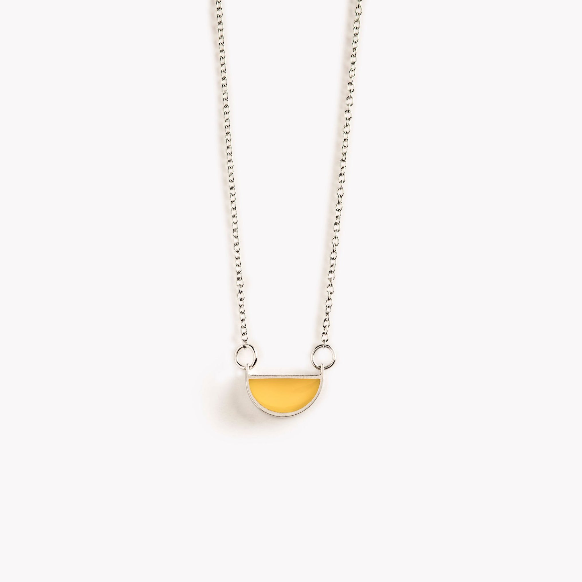 A simple, bright yellow, half circle shaped pendant necklace.