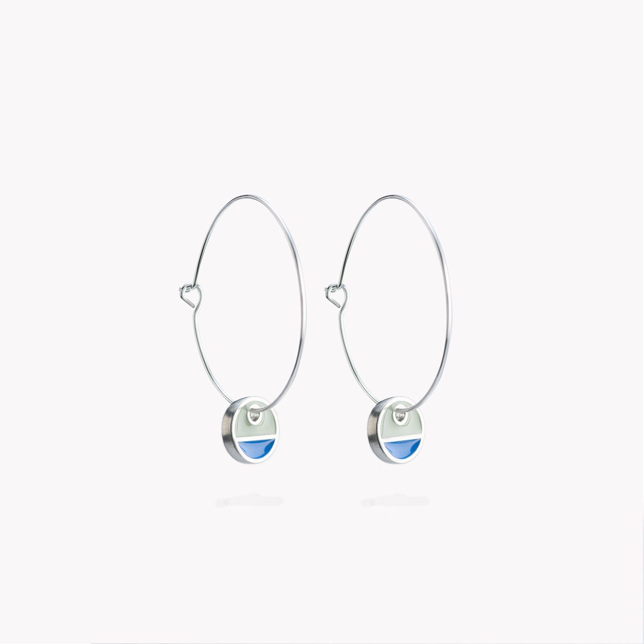 A simple pair of hoop earrings with blue and grey circular hanging discs.