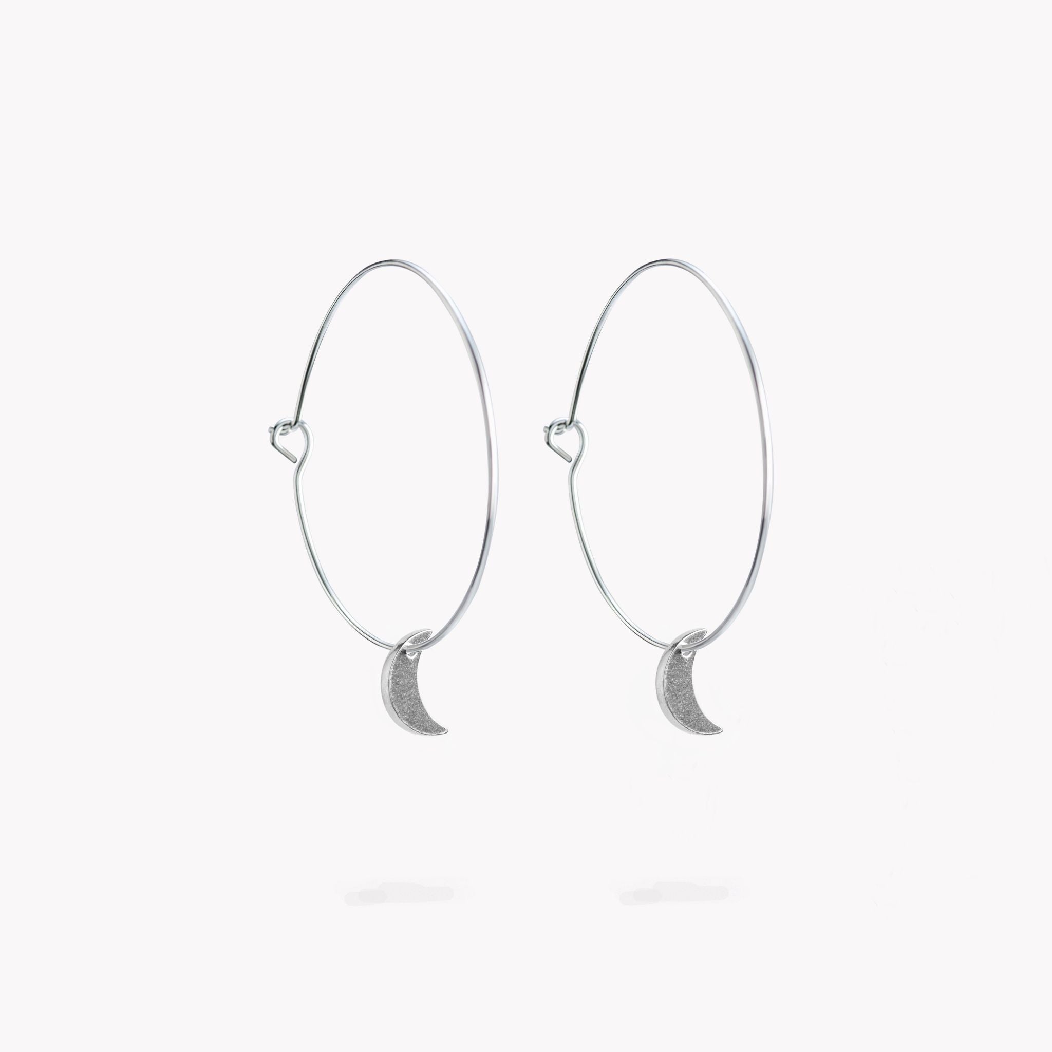 An elegant pair of pewter hoop earrings with a simple crescent moon design.