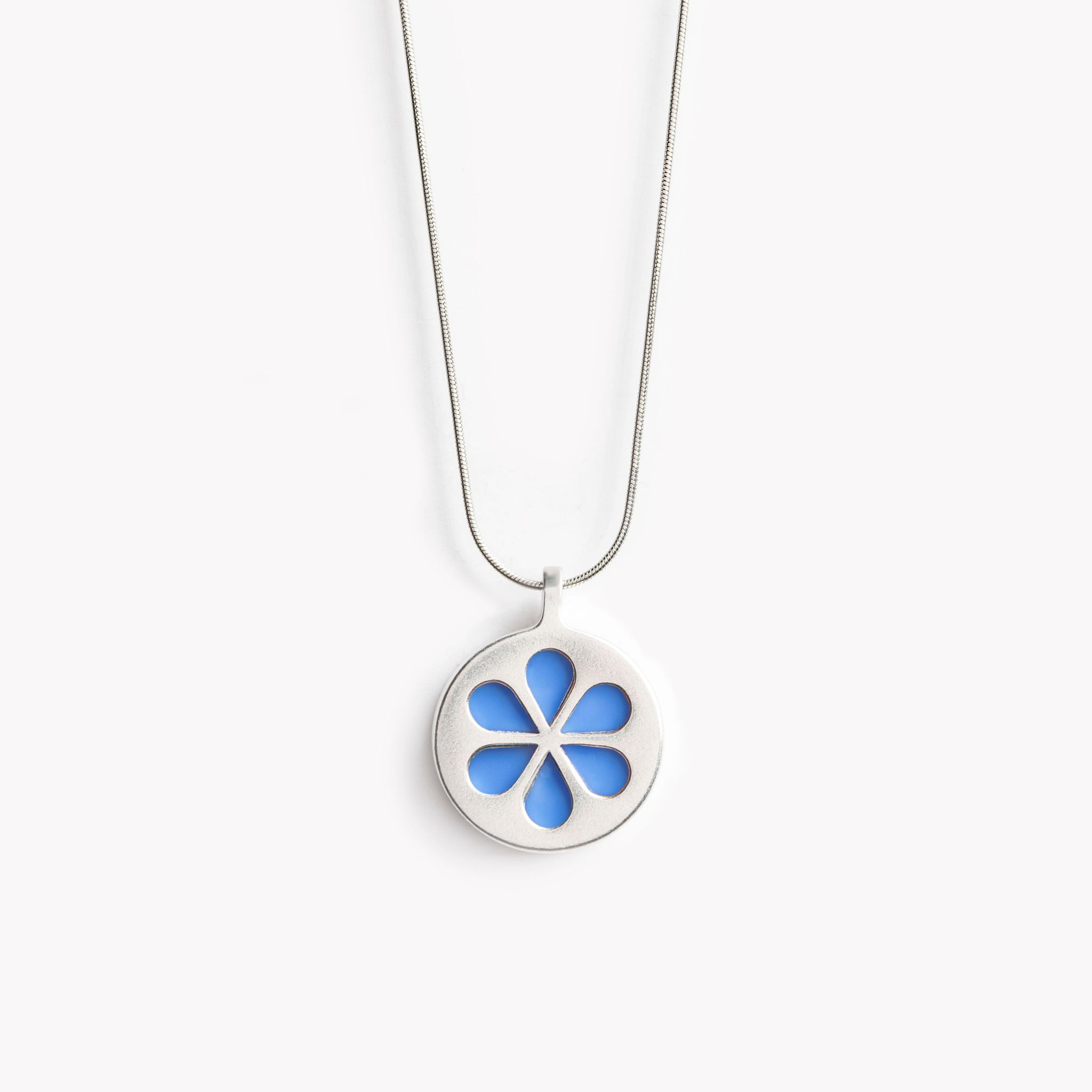 A simple circular pendant necklace with a bright blue flower petal design.