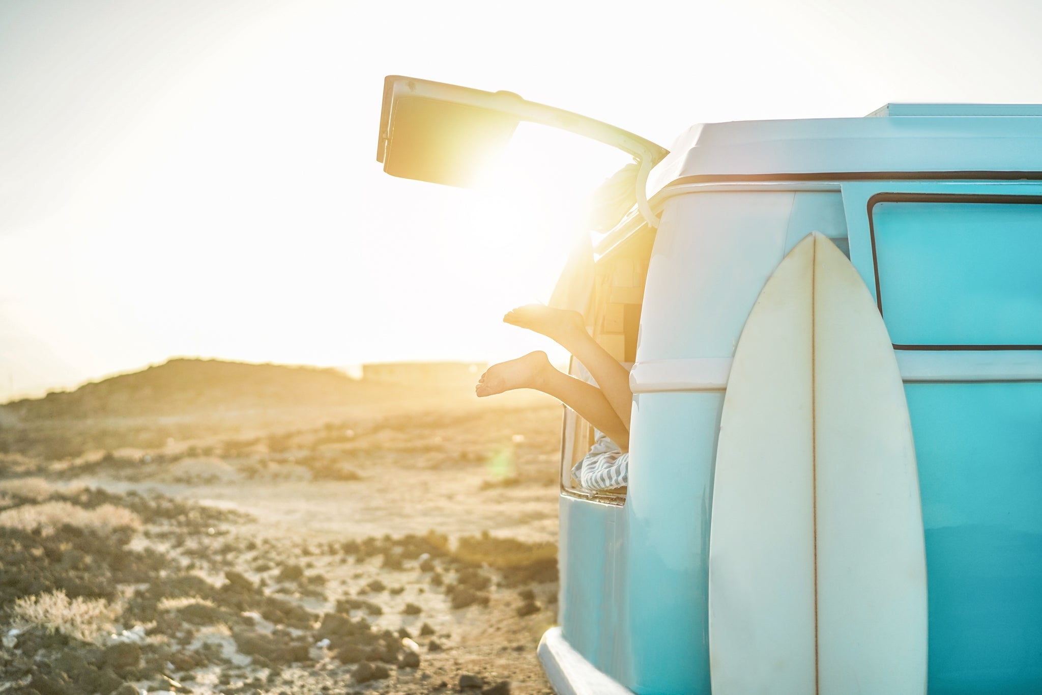 turquoise vw camper on the beach