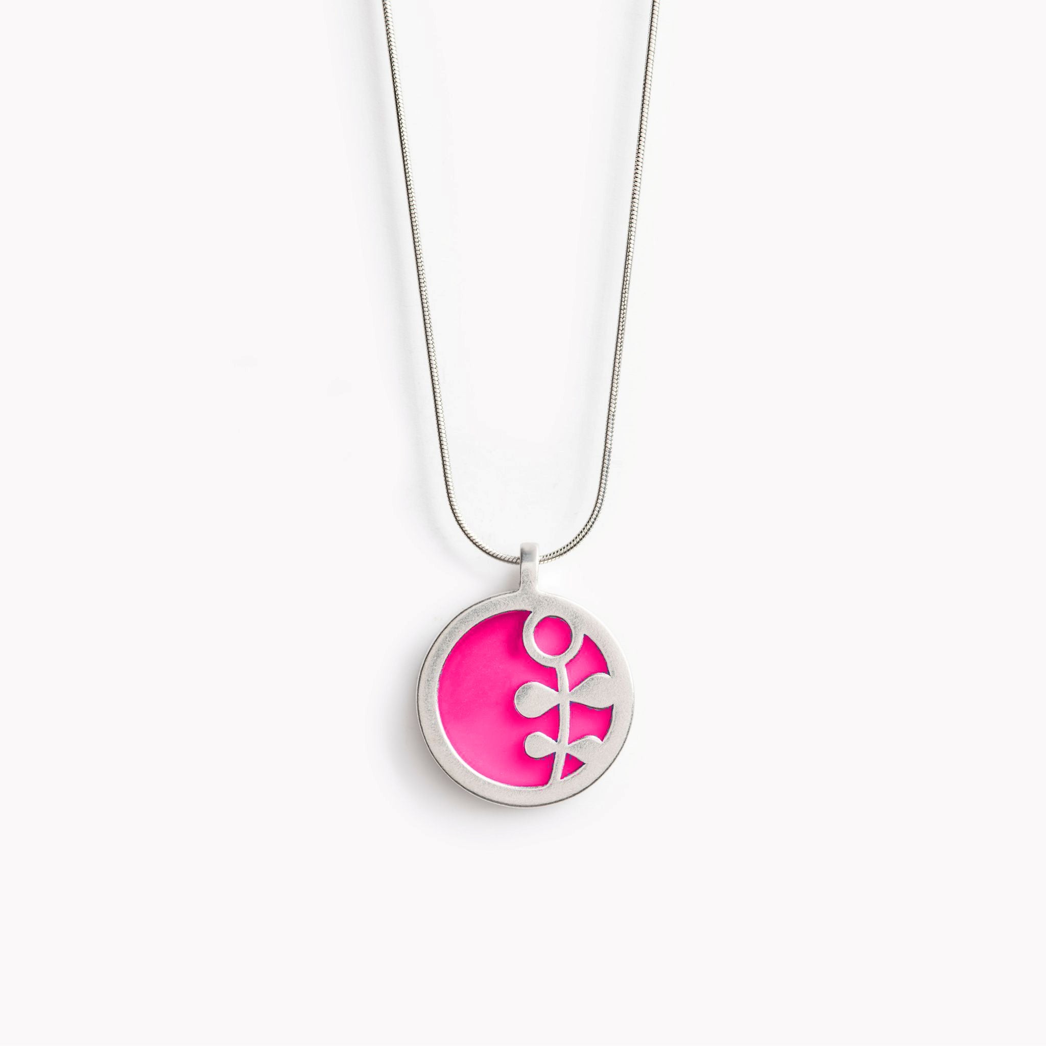 A simple circular pink pendant with a central Scandinavian flower design.