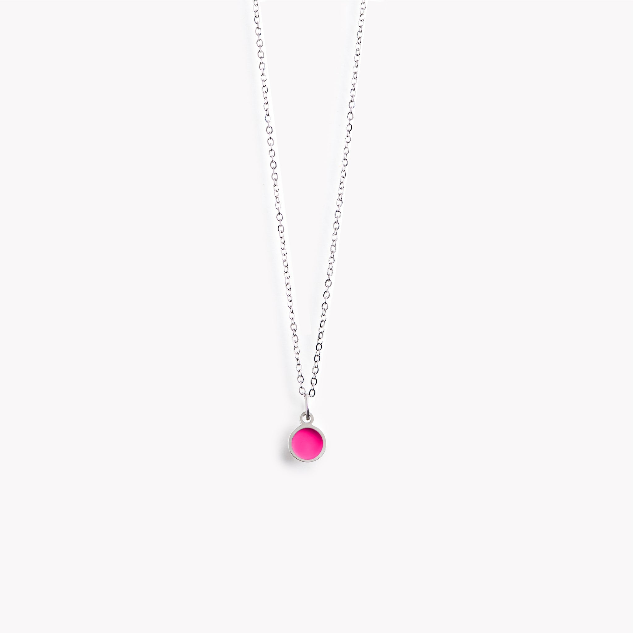 A simple, delicate, circular necklace with a hot pink centre and a polished pewter surround.