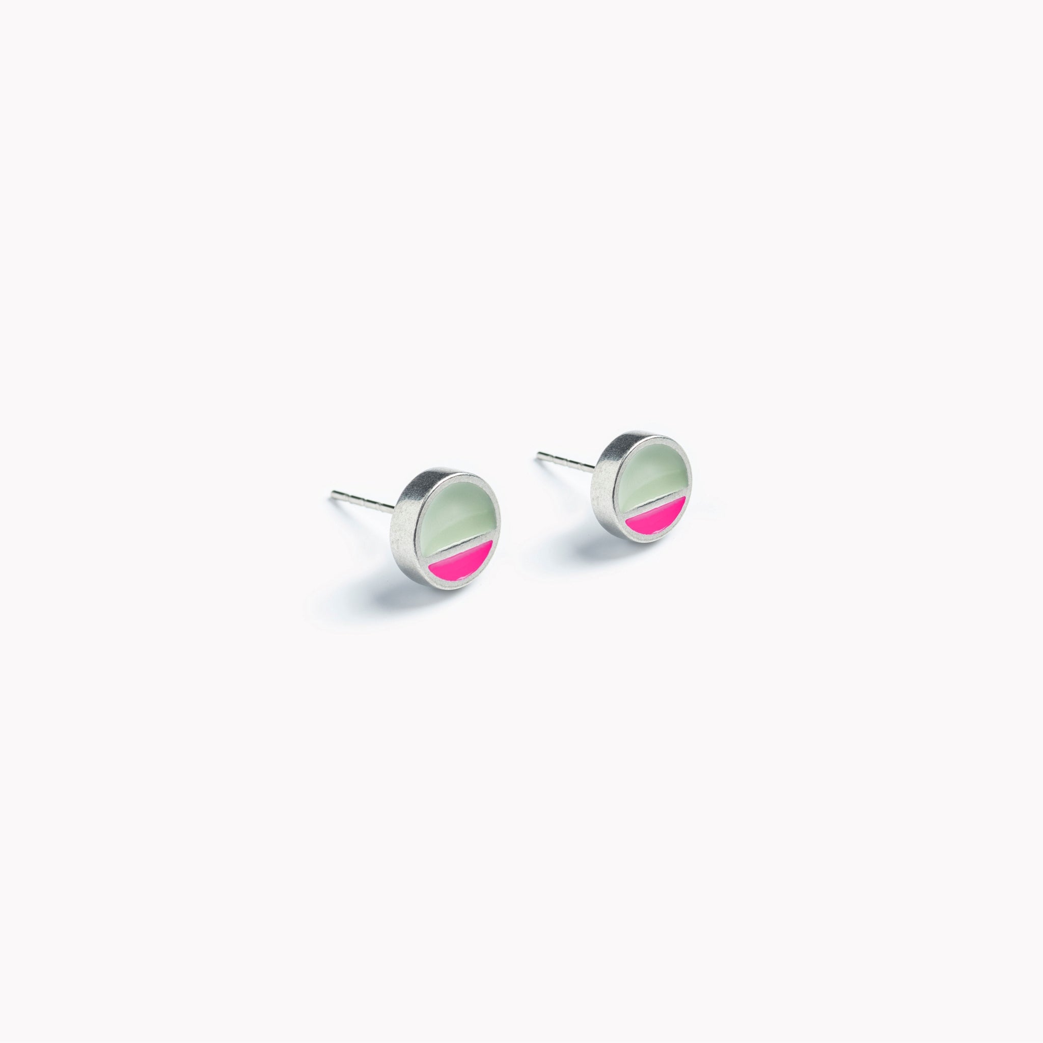 A simple pair of circular stud earrings with a horizontal division. In pink and grey.