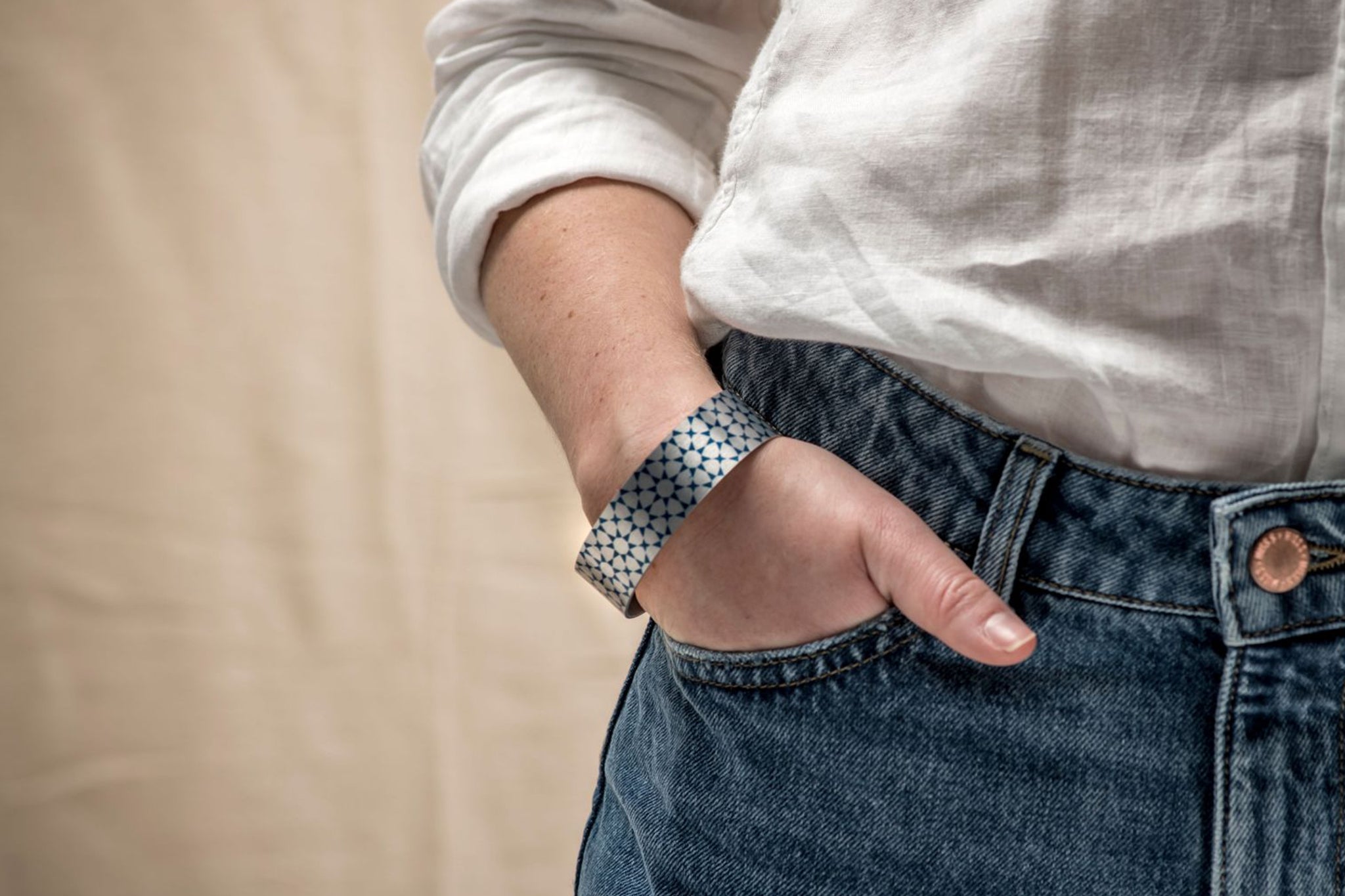 A model wears an intricate turquoise cuff bracelet.