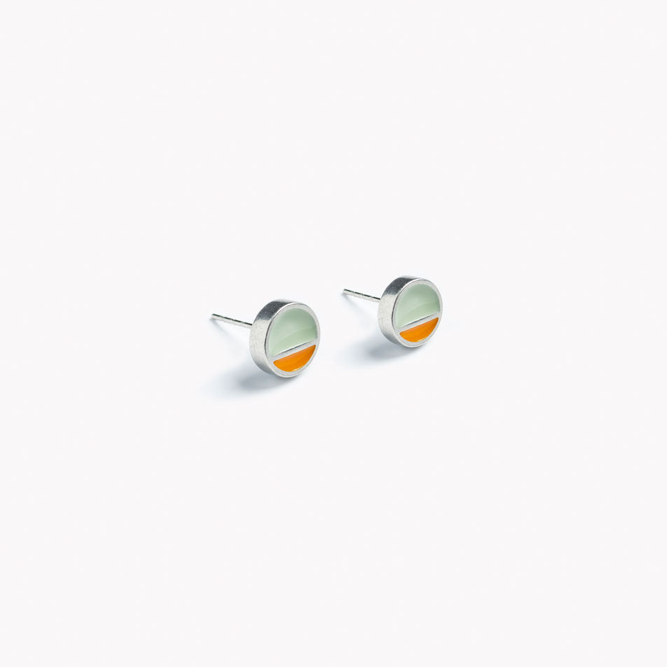 A simple pair of circular stud earrings with a horizontal division. In orange and grey.