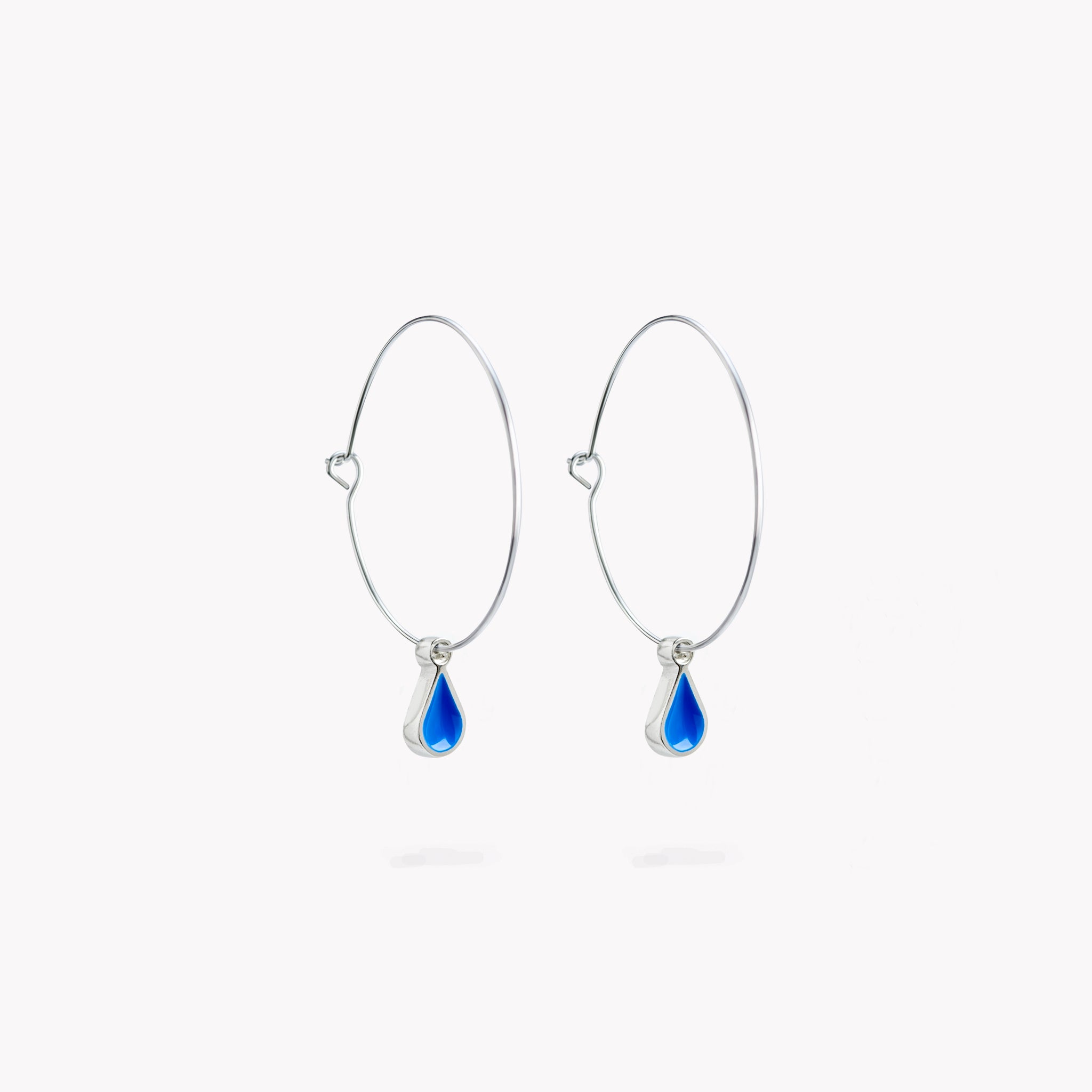 A simple pair of hoop earrings with bright blue hanging droplets.