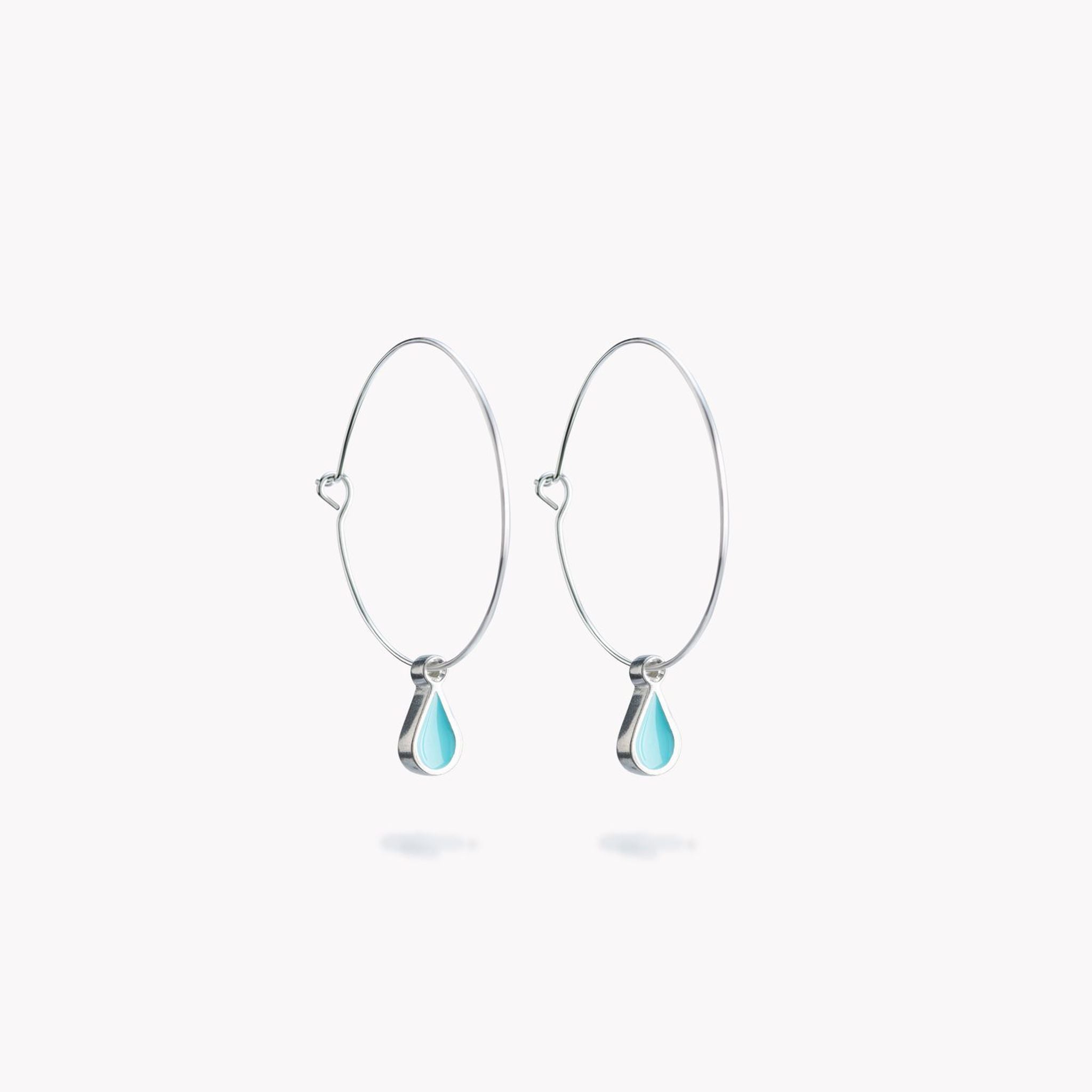 A simple pair of hoop earrings with turquoise hanging droplets.