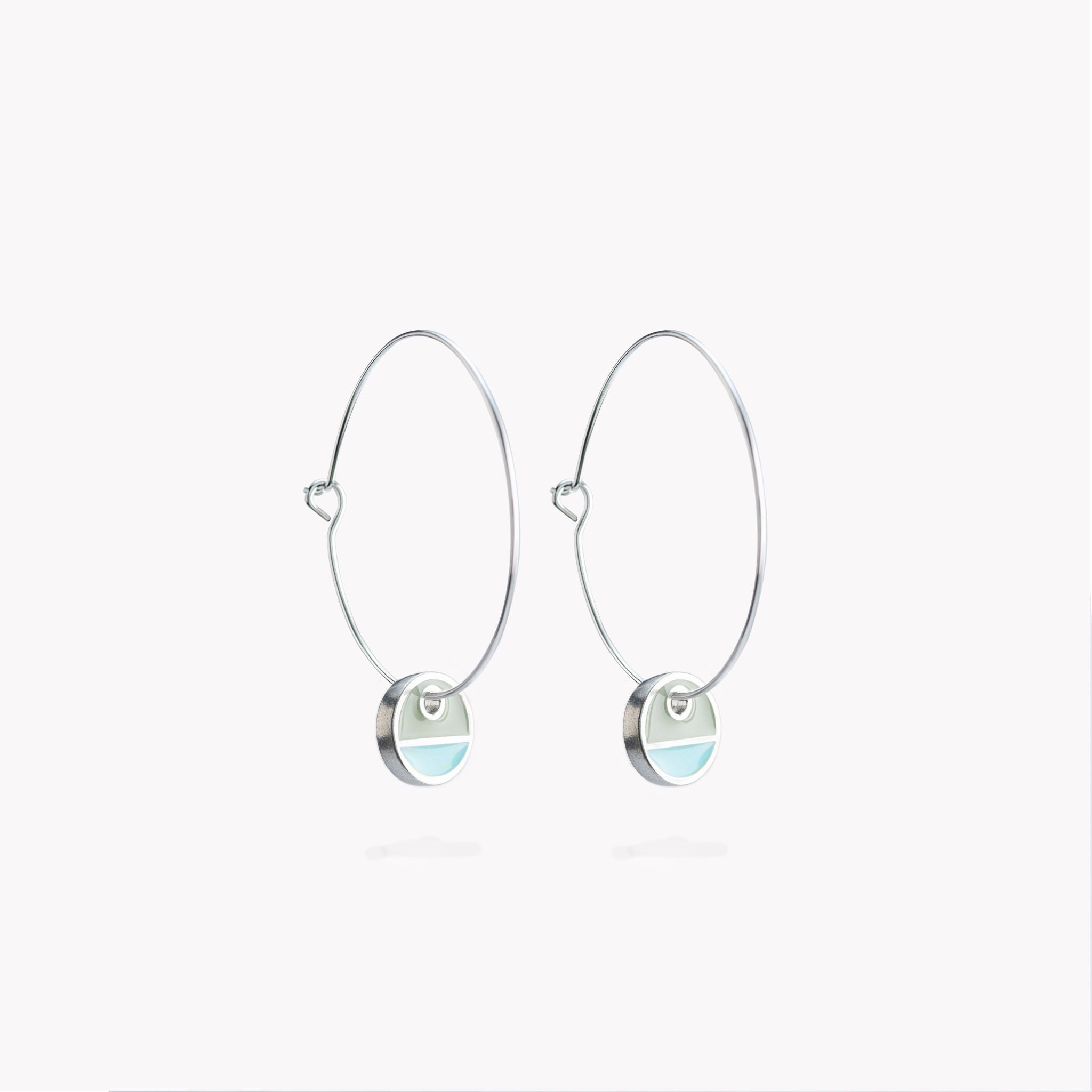 A simple pair of hoop earrings with turquoise and grey circular hanging discs.