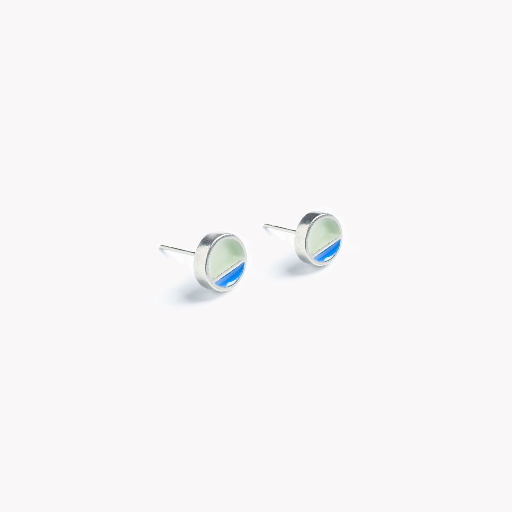A simple pair of circular stud earrings with a horizontal division. In blue and grey.