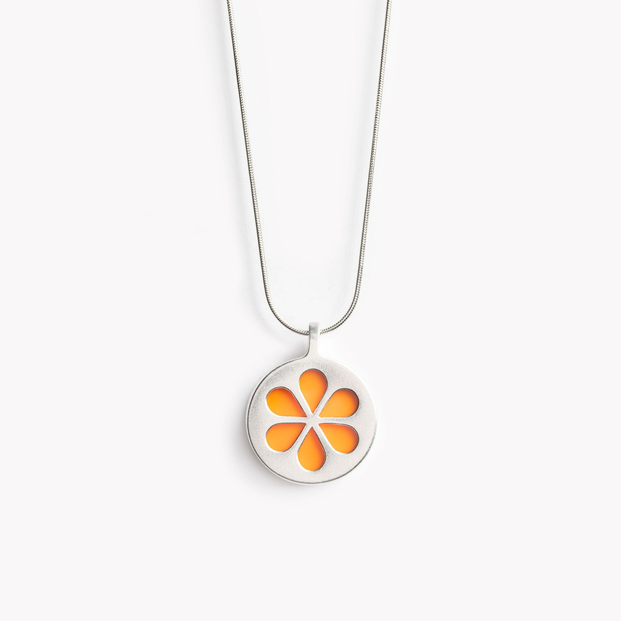 A simple circular pendant necklace with a bright orange flower petal design.