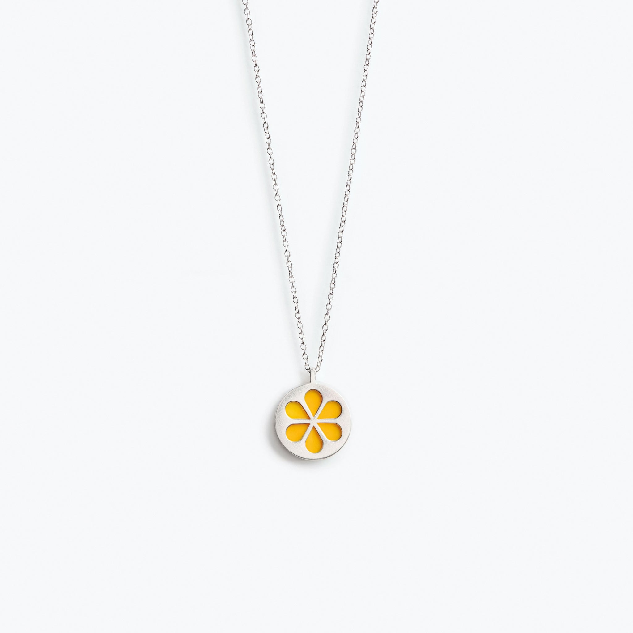 A simple orange flower pendant necklace, mounted on a fine trace chain.